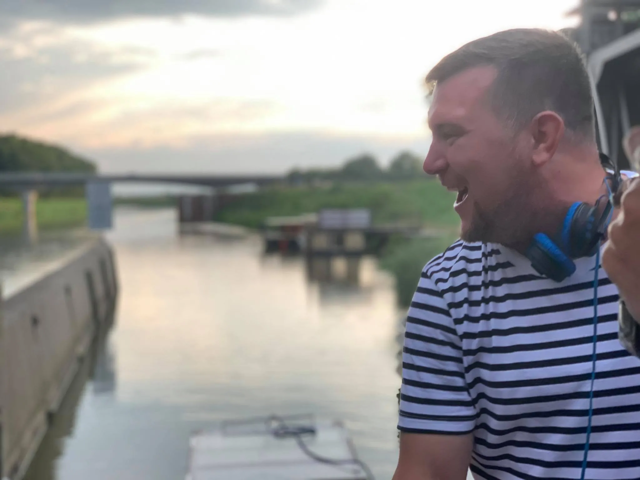 Ian Kita laughing at a boat party on the river, 2020